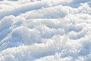 Hoarfrost background texture. Fresh ice and snow winter backdrop with snowflakes and mounds. Seasonal wallpaper.