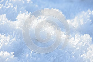 Hoarfrost background texture. Fresh ice and snow winter backdrop with snowflakes and mounds. Seasonal wallpaper.