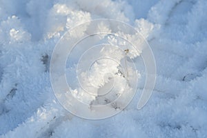 Hoarfrost background texture. Fresh ice and snow winter backdrop with snowflakes and mounds. Seasonal wallpaper.