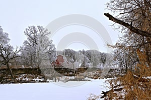 Hoarfrost with old red barn in the background
