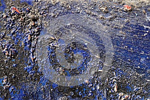 Hoarse, scratched and peeled surface with blue and black paint