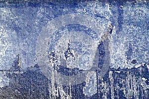 Hoarse, scratched and peeled surface with blue and white paint