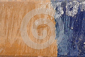 Hoarse,scratched and peeled surface with blue and yellowish-bro photo