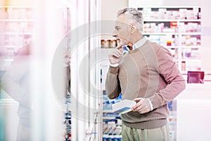 Hoary man thoughtfully staring at glass case