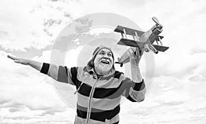 hoary senior retired man. mature man at retirement. old man on sky background with toy plane outdoor