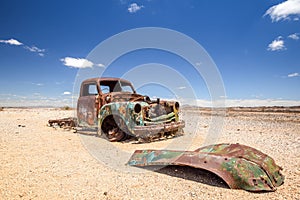 Close up of an old, rusty car wreck in the Namibian desert