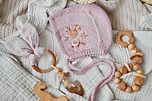 Hobbies and handicrafts. Knitted beanie with handmade embroidery. Wooden toys, rattles, teethers, nipple holder. Baby development