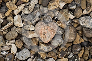 Hobby: Close up of a hand carved heart pendant from pink granite. 4