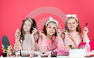 Hobby and fun. Happy girls doing makeup. Cute sisters play with cosmetics. Kids makeup. Beauty and fashion. Beauty salon