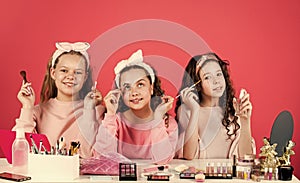 Hobby and fun. Happy girls doing makeup. Cute sisters play with cosmetics. Kids makeup. Beauty and fashion. Beauty salon
