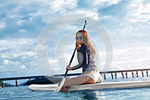 Hobby. Girl Paddling On Surfboard. Summer Travel.