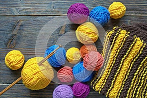 Hobby and knitting concept. Colorful balls of wool and knitting needles
