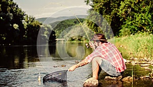 Hobby for soul. United with nature. Fisherman fishing technique use rod. Man catching fish. Guy fly fishing. Successful