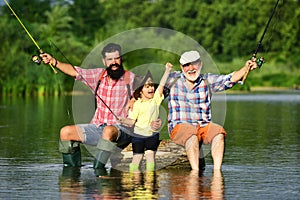 Hobby and sport activity. Happy people family have fishing and fun together. Dad and son fishing at lake. Grandpa and
