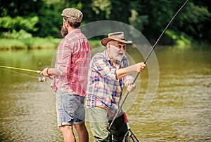 Hobby sport activity. Summer weekend. Peaceful activity. Nice catch. Rod and tackle. Father and son fishing. Fisherman