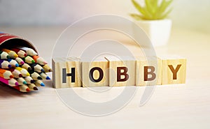 HOBBY word written on wooden blocks with collor pencils.