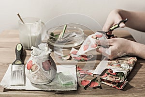 Hobbyist working on decoupage decorations.