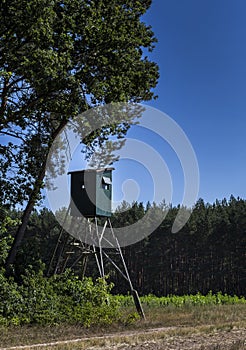 High stand for the hunter in a glade in the forest photo