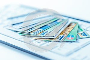 Group of credit cards on computer keyboard with VISA and MasterCard brand logos