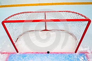 Hockey goal with puck on red line