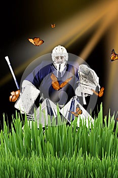 Hockey goalie stands in grass ready to catch  butterflies.