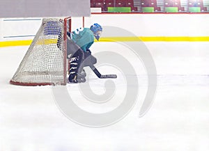 Hockey goalkeeper in helmet and gate