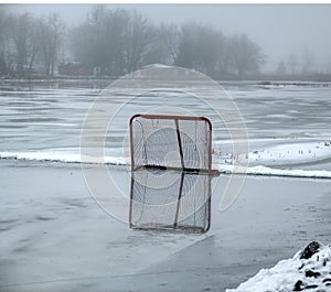 Hockey net reflecting on a frozen lake in Peterborough, Ontario