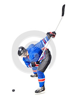 Hockey player doing slap shot isolated on white