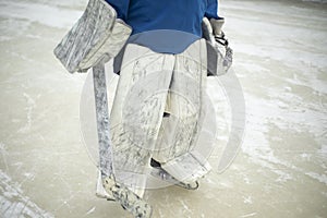 Hockey player, goalkeeper at stadium. Winter sport. Goalie on ice