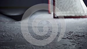 Hockey player on the ice slows sharply close-up