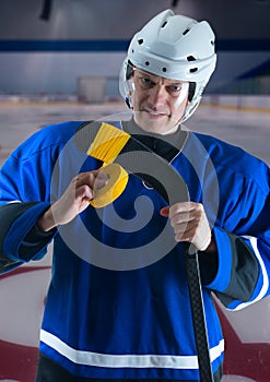 Hockey player taping his stick