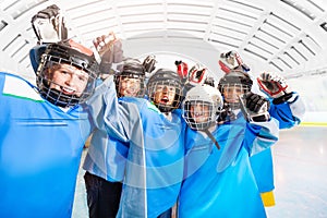 Hockey players celebrating victory on ice rink