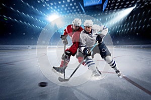 Hockey players shoots the puck and attacks photo