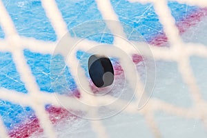 Hockey puck through goal net