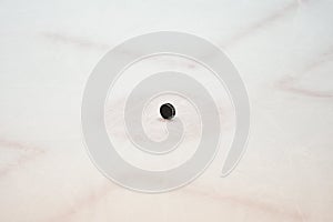 Hockey puck on ice arena