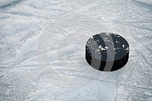 Hockey puck on ice hockey rink