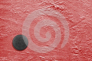 Hockey puck on ice red