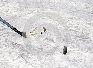 Hockey puck and stick on ice