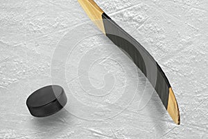 Hockey puck and stick on the ice