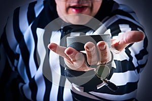 Hockey referee hold a puck photo