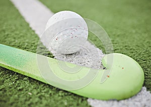 Hockey, stick and ball on green, field or pitch with sports equipment for game, competition or match on ground or floor