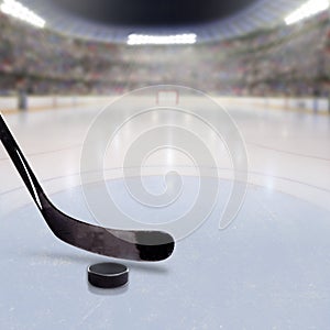 Hockey Stick and Puck on Ice of Crowded Arena photo