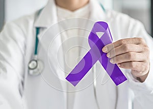 Hodgkin`s lymphoma and testicular cancer awareness violet ribbon symbolic bow color on doctorâ€™s hand support