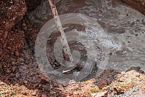 Hoe, in dig hole repair plumbing, with water motion