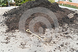 A hoe and soil fertile ground surface. Close up of natural pattern texture background. Top view of organic dirt in garden