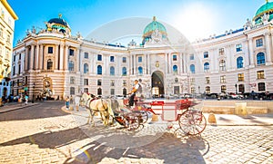 Hofburg Palace and horse carriage on sunny Vienna street, Austria