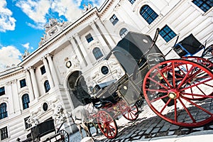 Hofburg Palace with traditional Fiaker carriage in Vienna, Austria