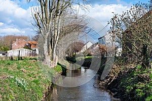 The Hoge Molenbeek creek through the meadows at the Belgian countryside around Merchtem, Belgium