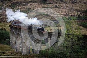Hogwarts Express Jacobite steam train on Glenfinnan Viaduct in Scotland photo