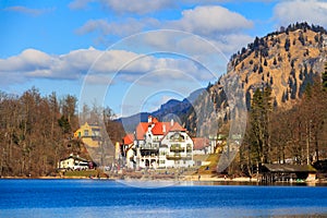 Hohenschwangau Castle, Alpsee lake, landscape view in spring, red maple fall foliage, Bavaria, Germany